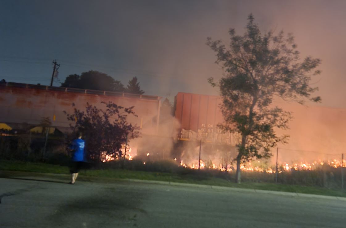 A grass fire that started next to train tracks in Calgary overnight Saturday spread quickly due to dry conditions, crews said.