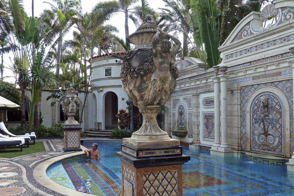 In this Tuesday, Dec. 26, 2017 file photo, a man lounges in the swimming pool at The Villa Casa Casuarina in Miami Beach, Fla.