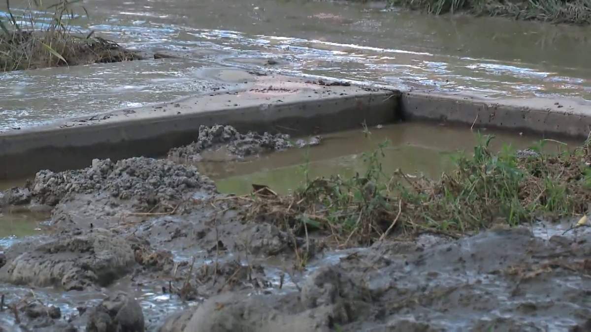 Thick mud covers properties in the area of 101 Street and 116 Avenue in Edmonton Monday, July 5, 2021, one day after a water main break in the area.
