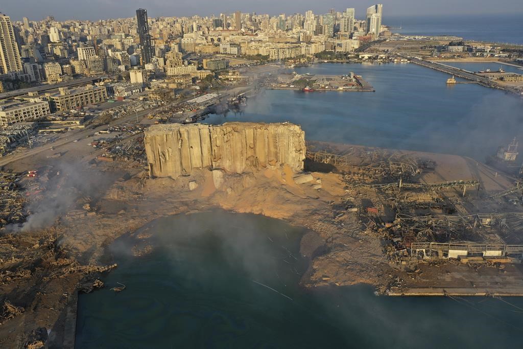 FILE - In this Aug 5, 2020 file photo, a drone camera captures the scene of an explosion that hit the seaport of Beirut, Lebanon. The Aug. 4 blast at Beirut's port tore through the city at 6:07 p.m., destroying entire neighbourhoods and killing scores of people. (AP Photo/Hussein Malla, File).