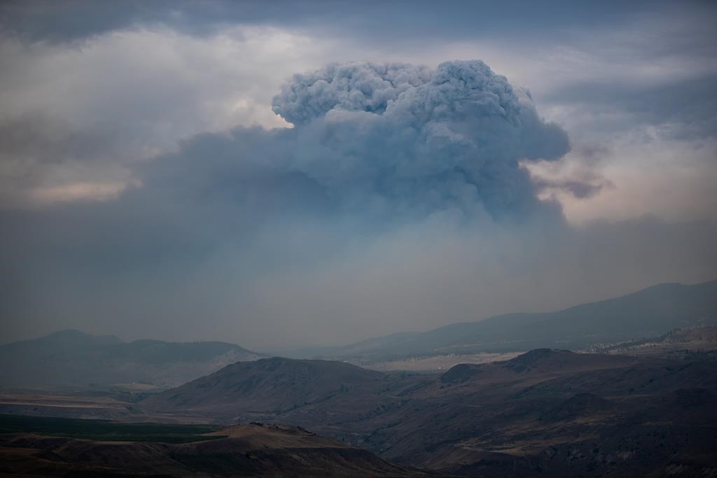 A pyrocumulus cloud, also known as a fire cloud, forms in the sky as the Tremont Creek wildfire burns on the mountains above Ashcroft, B.C., on July 16, 2021. THE CANADIAN PRESS/Darryl Dyck.
