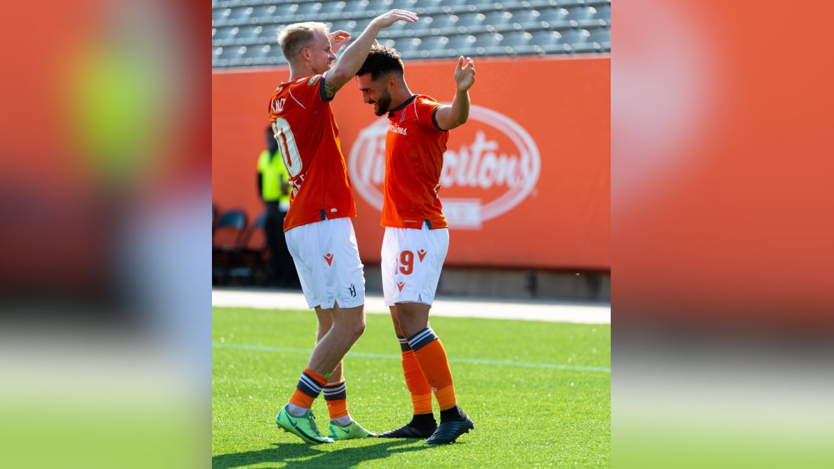 Kyle Bekker and Tristan Borges celebrate a Forge FC goal during a match against York United on Saturday Aug. 28, 2021.