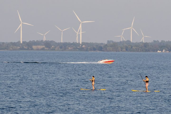 People paddle board in Lake Ontario during a warm and humid day in Kingston, Ontario on Tuesday July 6, 2021.