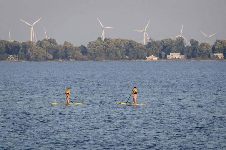 People paddle board in Lake Ontario during a warm and humid day in Kingston, Ontario on Tuesday July 6, 2021.