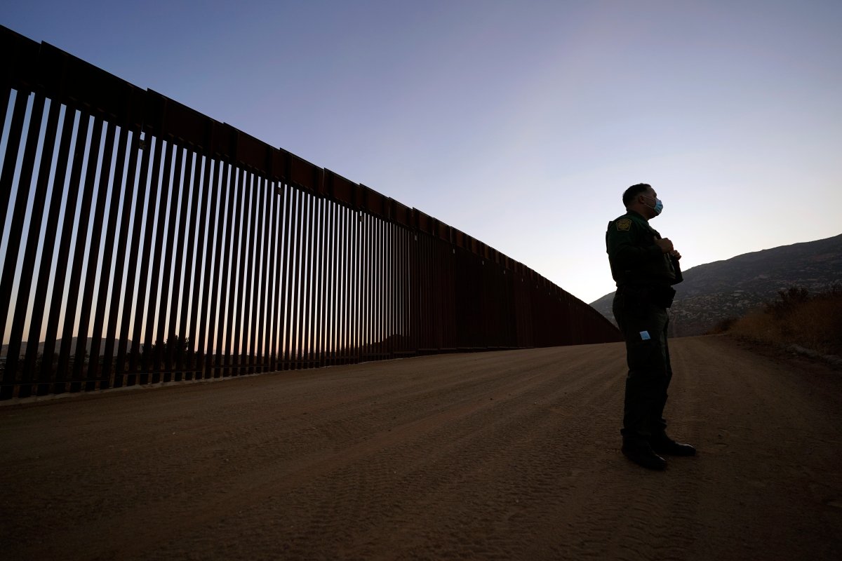 Border Patrol agent Justin Castrejon speaks in front of newly replaced border wall sections Thursday, Sept. 24, 2020, near Tecate, Calif.