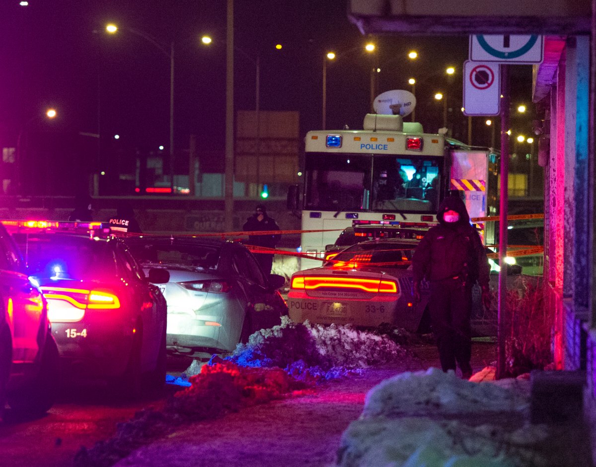 Police canvas area where an officer was injured during a traffic stop Thursday, January 28, 2021 in Montreal. 