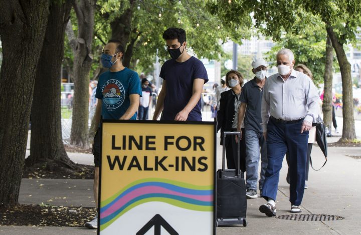 People line up to enter a vaccination clinic in Mel Lastman Square in Toronto on July 24, 2021.