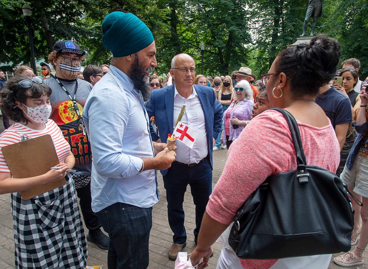 Federal NDP Leader Jagmeet Singh, left, and Nova Scotia NDP Leader Gary Burrill, centre, greet provincial candidates in Halifax on Wednesday, Aug. 11, 2021. 