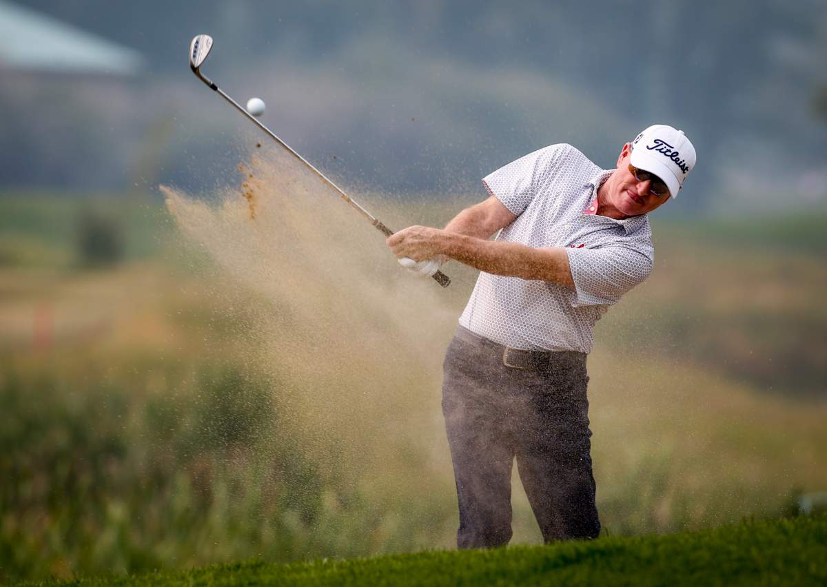 Steve Flesch, of the United States, hits from a sand trap at the 18th green during the PGA Tour Champion’s Shaw Charity Classic golf event in Calgary, Alta., Sunday, Aug. 15, 2021.