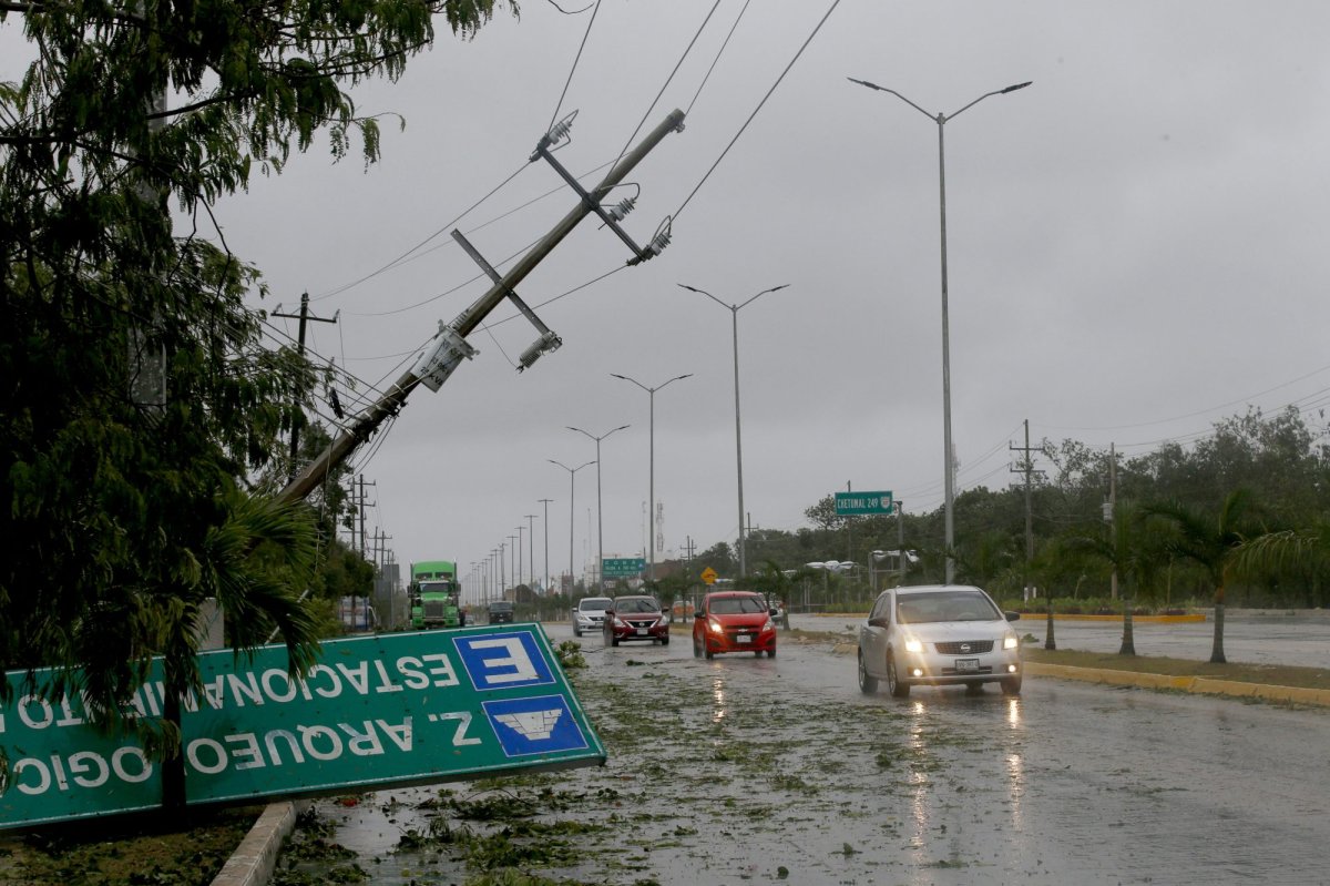 A road sign brought down by the winds of Hurricane Grace lays on the side of the highway in Tulum, Quintana Roo state, Mexico, Thursday, Aug. 19, 2021. The Category 1 storm made landfall at 4:45 a.m., just south of the ancient Mayan temples of Tulum, pelting the Caribbean coast with heavy rain and pushing a dangerous storm surge. (AP Photo/Marco Ugarte).