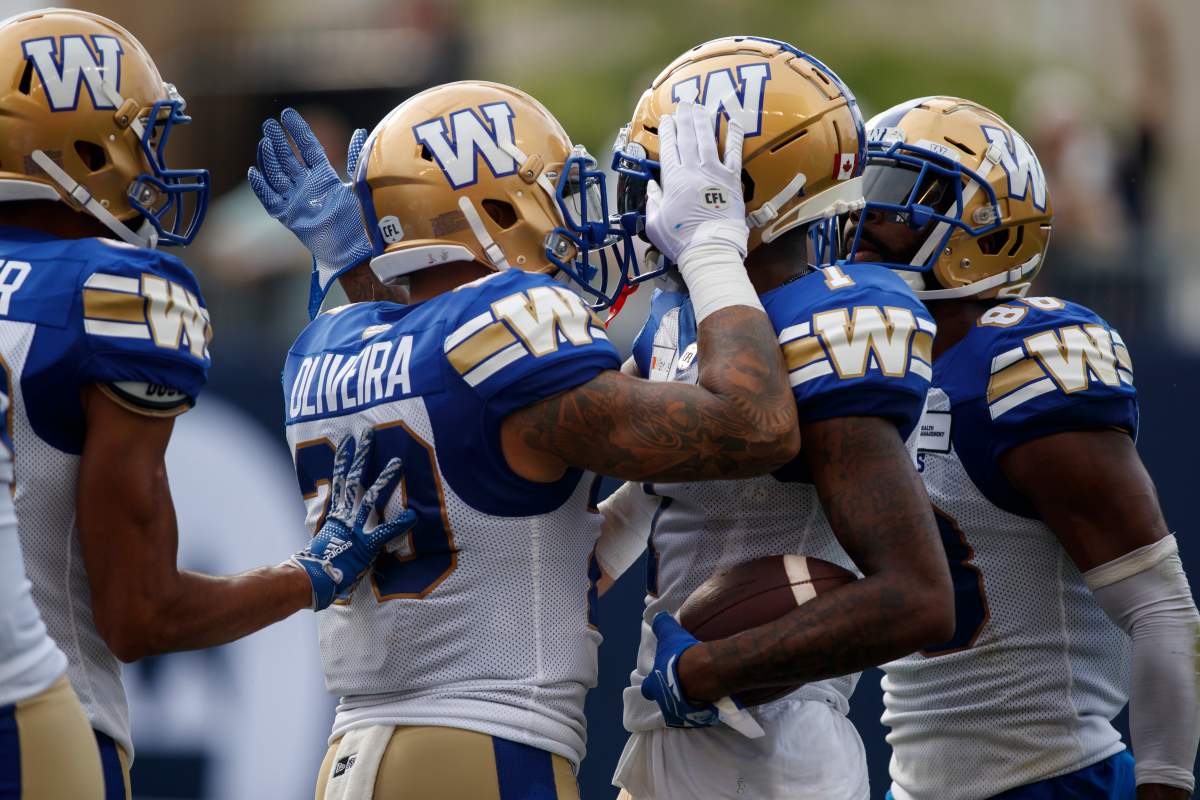 Winnipeg Blue Bombers wide receiver Darvin Adams (1) celebrates his touchdown with teammate Brady Oliveira (20) during first half CFL football action against the Toronto Argonauts, in Toronto, Saturday, Aug. 21, 2021.