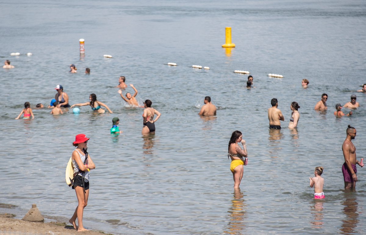 People cool down in the St. Lawerence River as temperatures soar in Montreal, Sunday, August 22, 2021. 