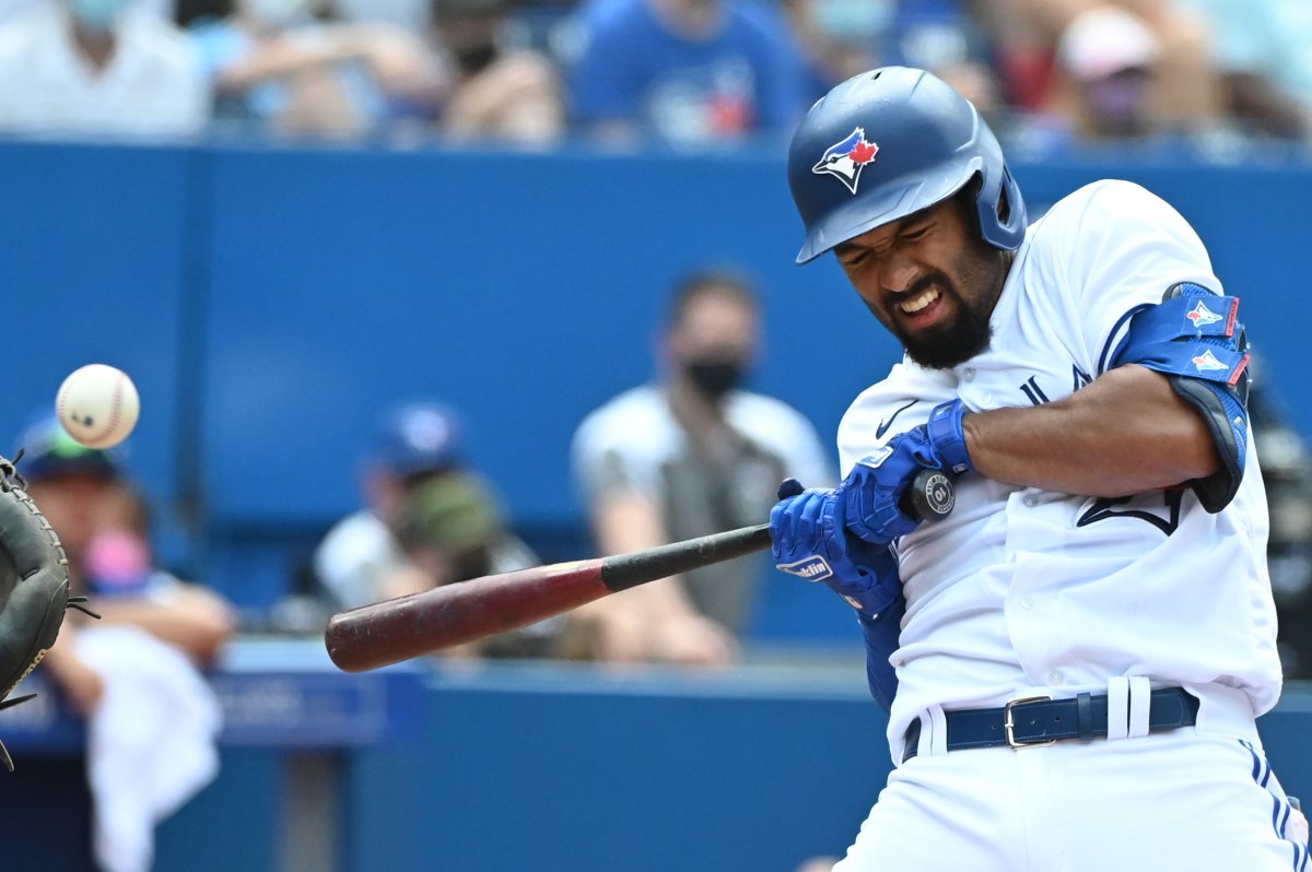 Toronto Blue Jays' Marcus Semien reacts after being hit by a pitch from Detroit Tigers' Jose Cisnero, not seen, in the seventh inning of an American League baseball game in Toronto on Sunday, Aug. 22, 2021. 