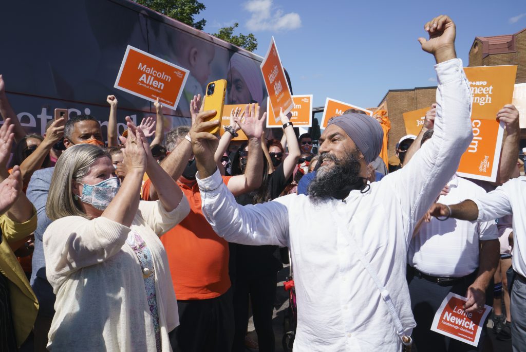 NDP leader Jagmeet Singh records a video for social media and is applauded by Ontario NDP leader Andrea Horwath during a campaign stop in Hamilton, Ont., on Tuesday, August 24, 2021. THE CANADIAN PRESS/Paul Chiasson.