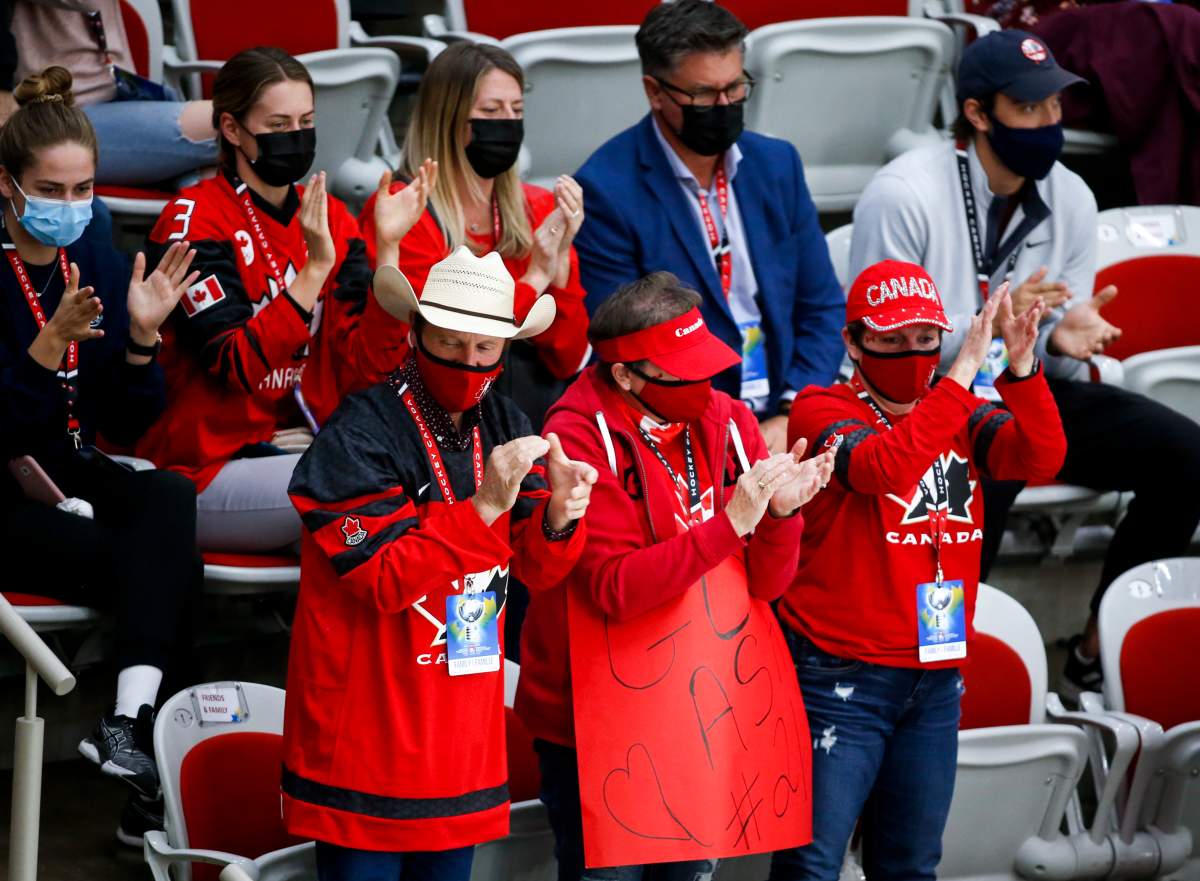 Family members cheer a Team Canada goal during second period IIHF Women’s World Championship hockey action against United States in Calgary, Thursday, Aug. 26, 2021.