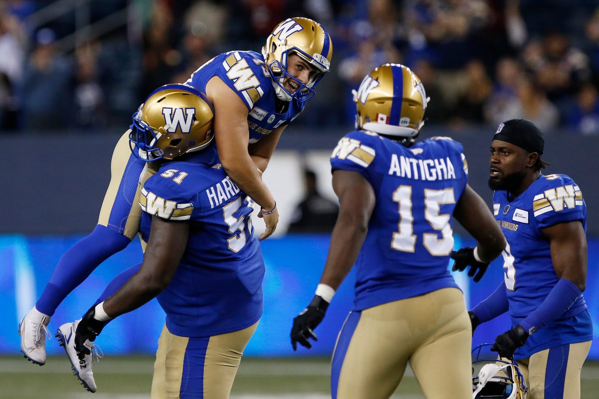 Winnipeg Blue Bombers' kicker Marc Liegghio (13) celebrates with Jermarcus Hardrick (51) after kicking the game winning field goal against the Calgary Stampeders during second half CFL football action in Winnipeg, Sunday, Aug. 29, 2021.