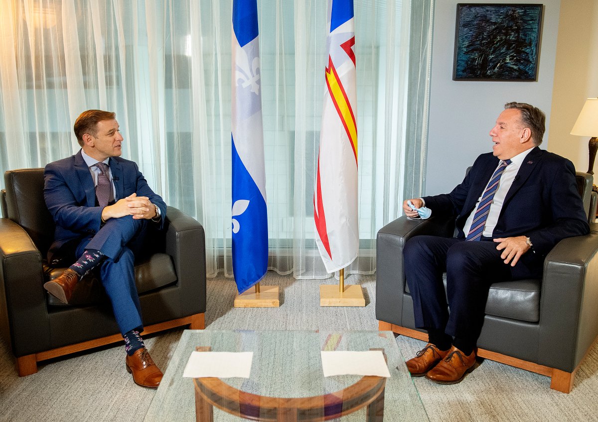 Quebec Premier Francois Legault, right, speaks with Newfoundland and Labrador Premier Andrew Furey during a meeting in Montreal, Monday, August 30, 2021.