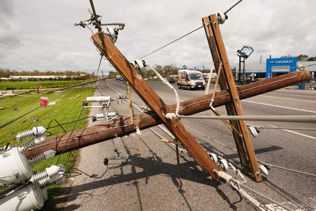 Ambulances pass by a downed power pole after Hurricane Ida moved through Monday, Aug. 30, 2021, in LaPlace, La. (AP Photo/Steve Helber)