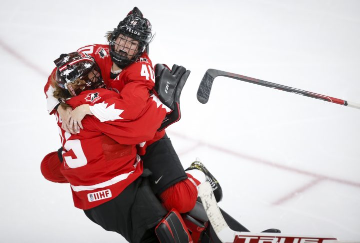 Canada's goalie Ann-Renee Desbiens, left, and Blayre Turnbull celebrate winning the gold medal final against the United States in IIHF Women's World Championship hockey action  in Calgary, Tuesday, Aug. 31, 2021.THE CANADIAN PRESS/Jeff McIntosh.