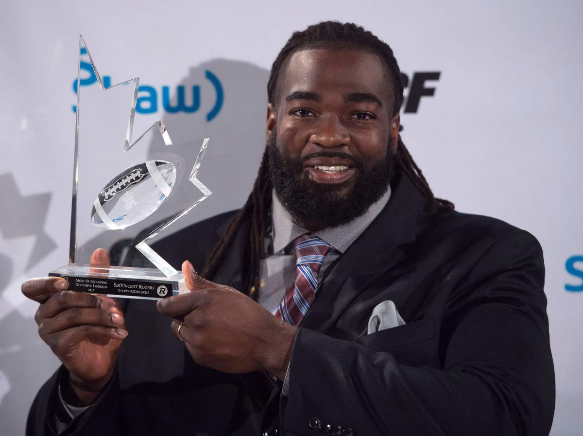 SirVincent Rogers poses for photographs after winning the CFL's most outstanding offensive lineman award during the Canadian Football League awards in Winnipeg on Thursday November 26, 2015. 