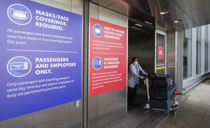 A passenger wearing a face mask leaves Terminal 1 of Pearson International Airport on Aug. 3, 2020.