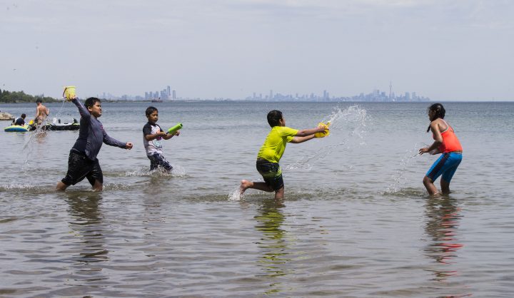 Children have a water fight at Lake Ontario in Mississauga on June 5, 2021.
