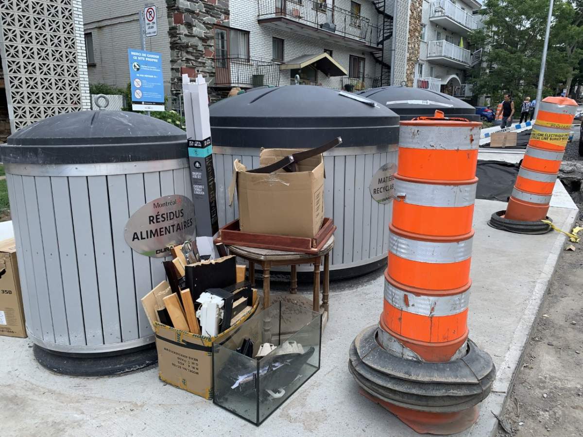 Waste piled up outside of garbage bins installed on Jubenville Avenue as part of a pilot project in Montreal-North. Monday August 2nd, 2021.
