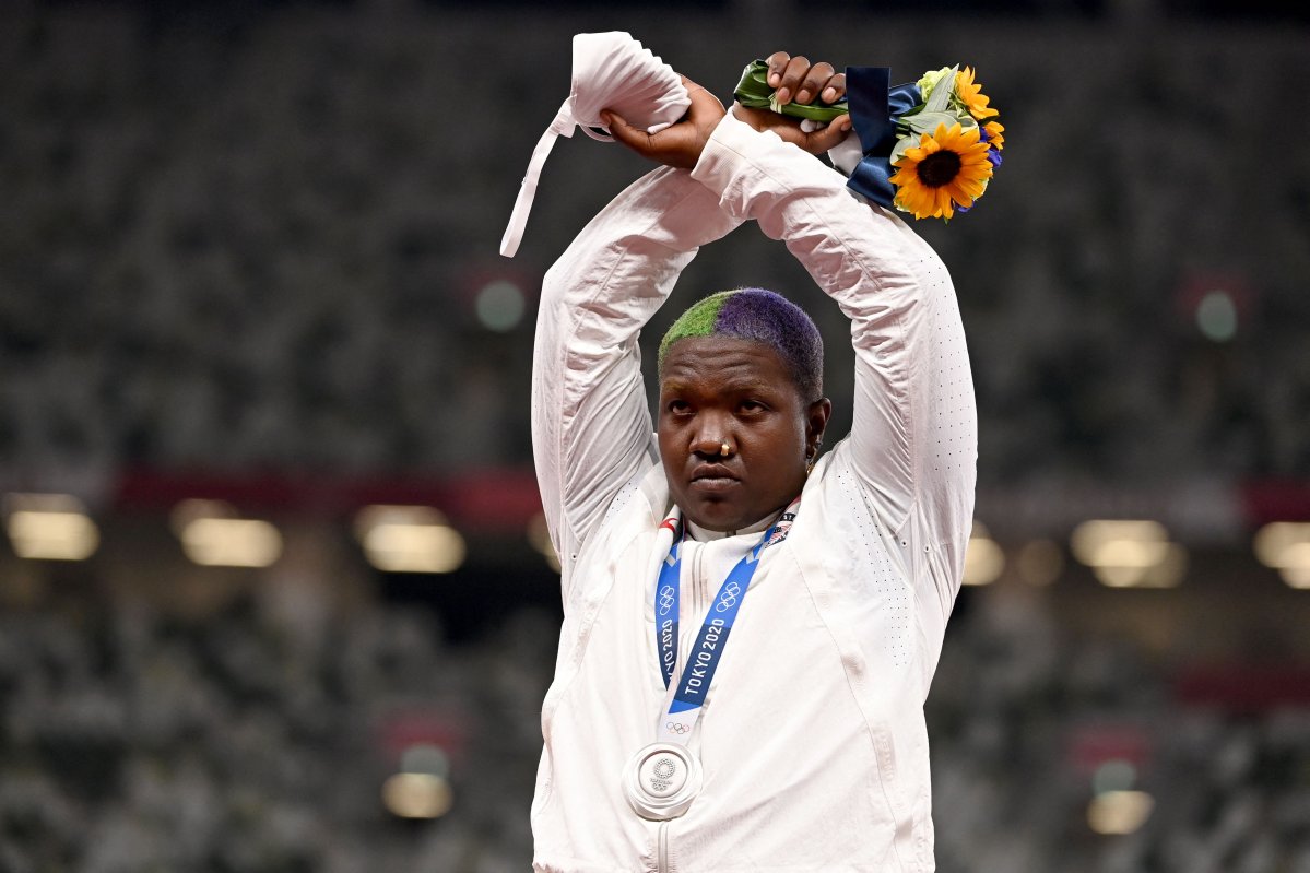Second-placed USA's Raven Saunders gestures on the podium with her silver medal after competing the women's shot put event during the Tokyo 2020 Olympic Games at the Olympic Stadium in Tokyo on August 1, 2021. 