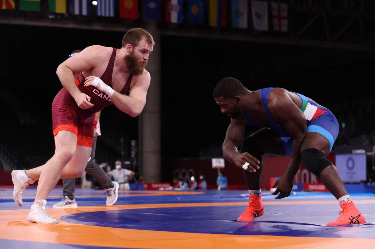 Canada’s Jordan Steen (red) wrestles Italy’s Abraham De Jesus Conyedo Ruano in their men’s freestyle 97kg wrestling repechage match during the Tokyo 2020 Olympic Games at the Makuhari Messe in Tokyo on August 7, 2021.