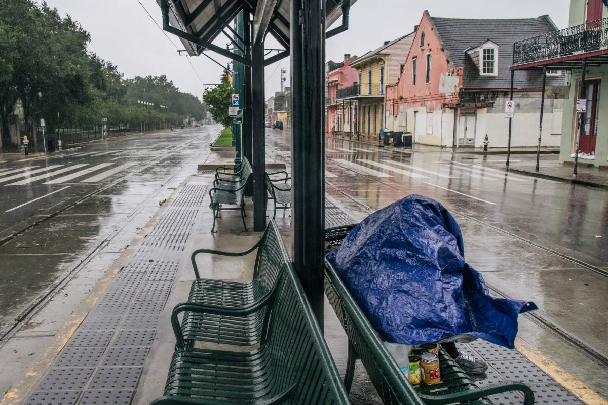 A person sits at a train stop for shelter ahead of Hurricane Ida on Aug. 29, 2021 in New Orleans, Louisiana.