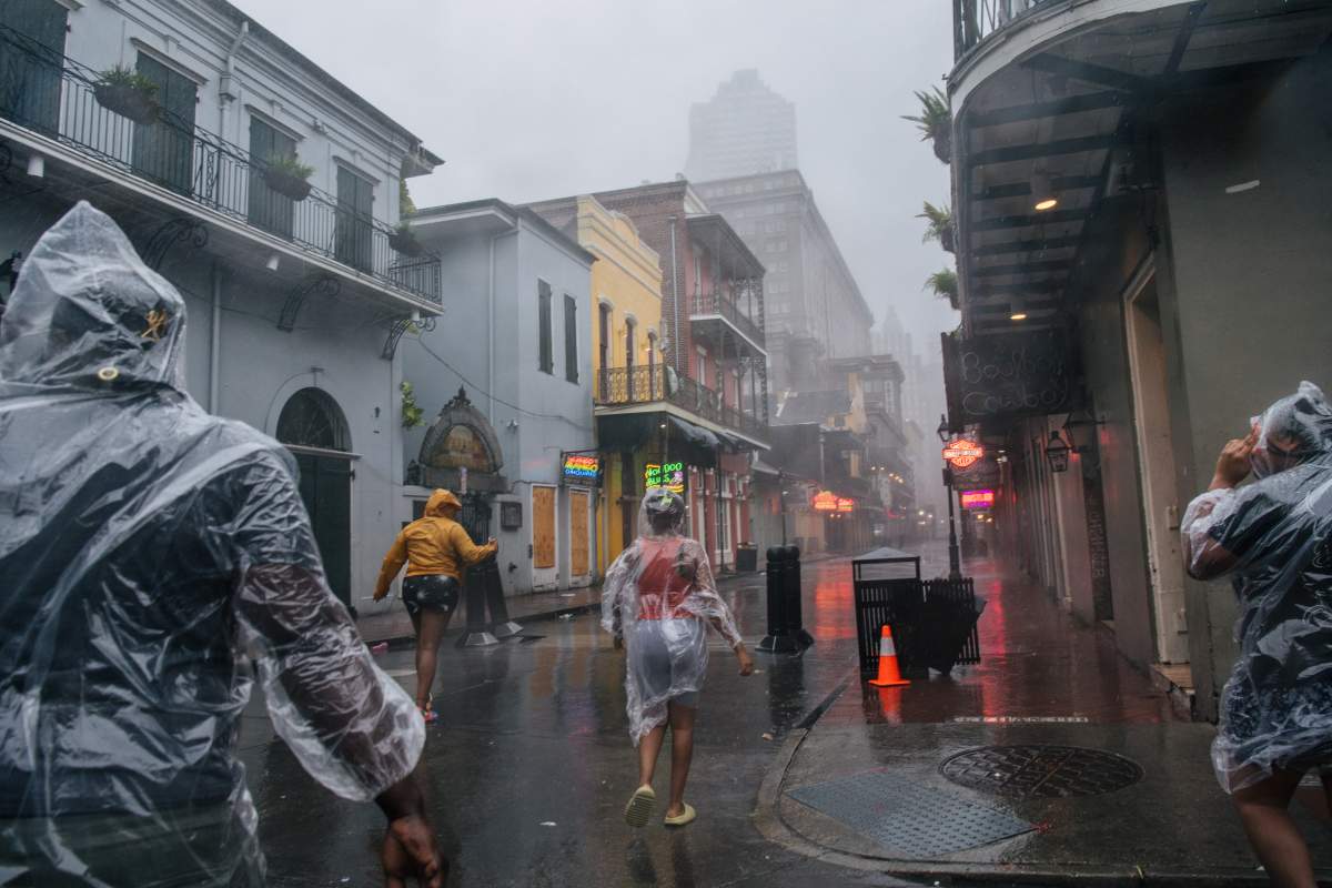 A group of people walk through the French District during Hurricane Ida on Aug. 29, 2021 in New Orleans, Louisiana.