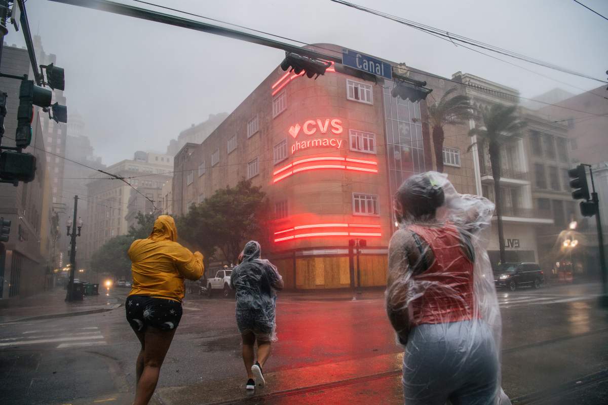 A group of people cross an intersection during Hurricane Ida on Aug. 29, 2021 in New Orleans, Louisiana.