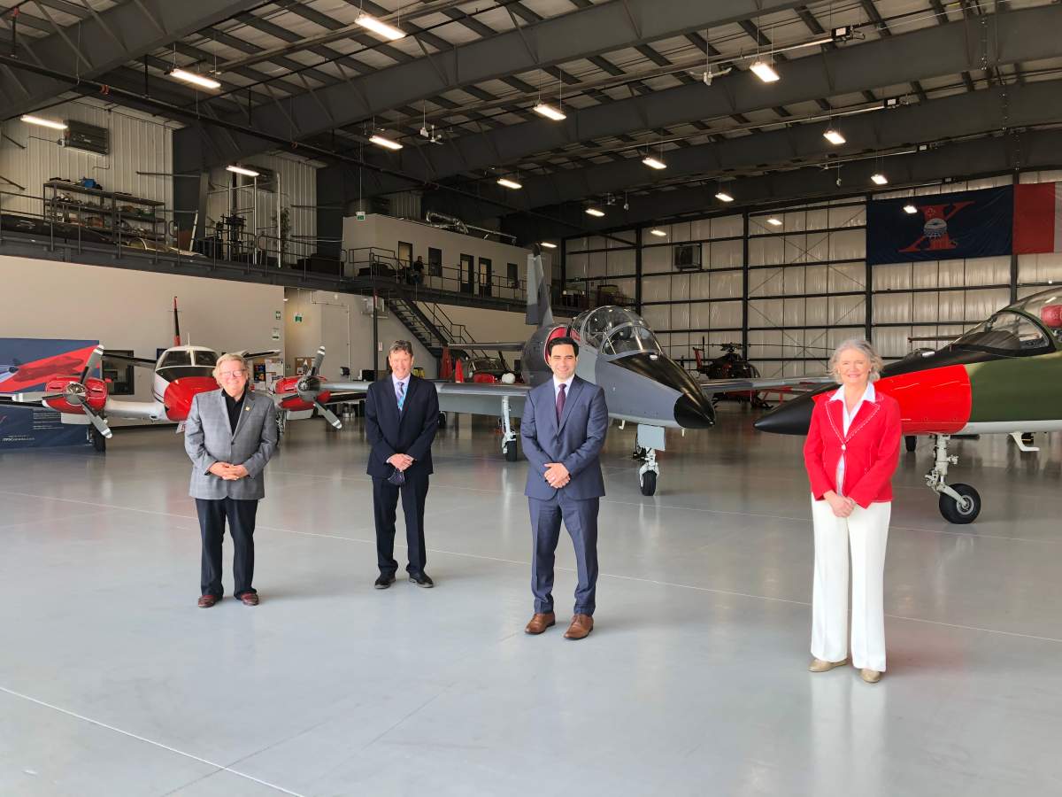From left to right: Mayor Ed Holder, London International Airport president and CEO Mike Seabrook, London North Centre MP Peter Fragiskatos and London West MP Kate Young stand inside one of several hangars at the airport.