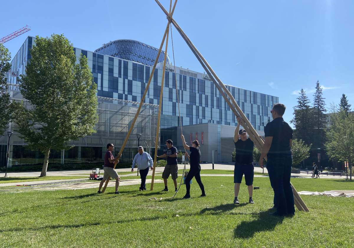 People set up a teepee at the University of Calgary on Monday, Aug. 30, 2021.