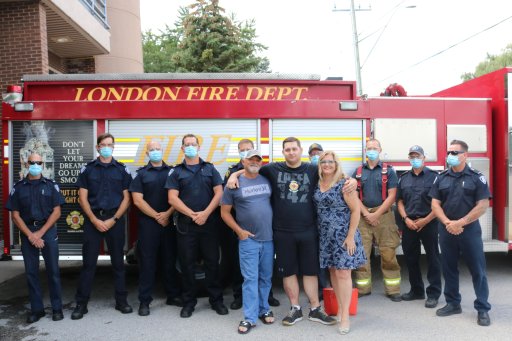Jacob Hurl and his parents at Station 3 posing with some of the firefighters who helped save his life during the Dec. 11, 2020, partial building collapse 555 Teeple Terrace in London Ont. on Aug. 30, 2021.
