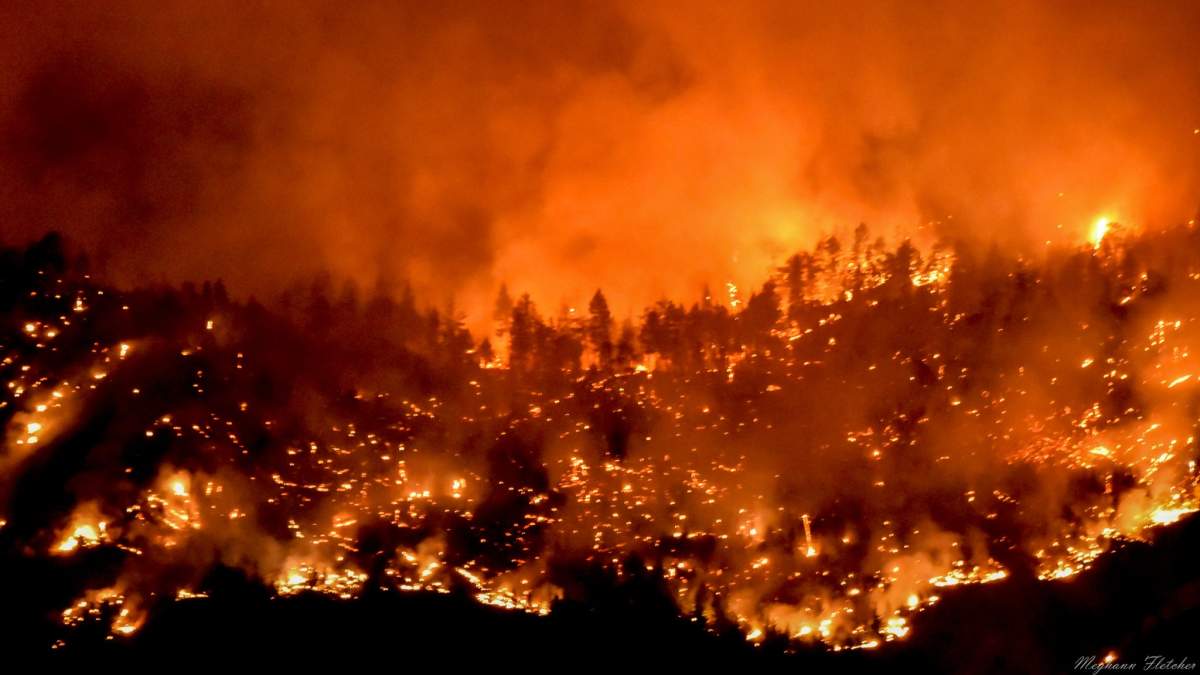 Meghann Fletcher captured this image of the Skaha Creek wildfire spreading across the hillside west of Penticton, B.C., on Sunday, Aug. 29, 2021.