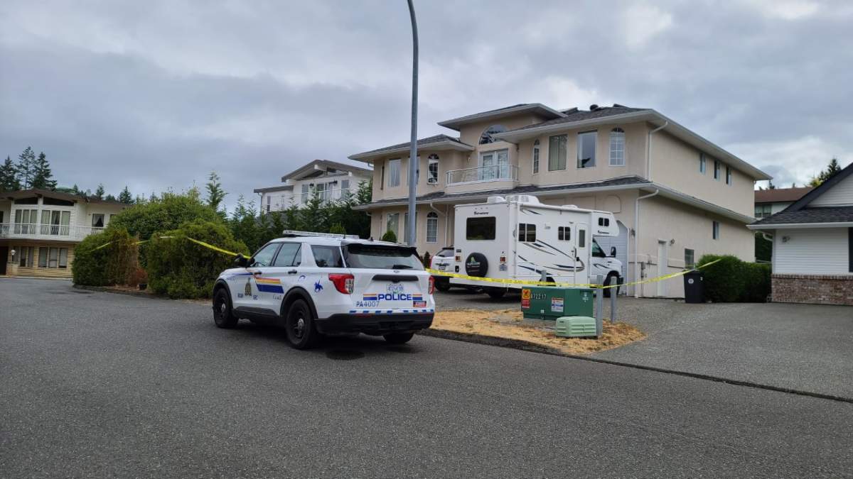 RCMP officers outside the home in Port Alberni Monday morning. 