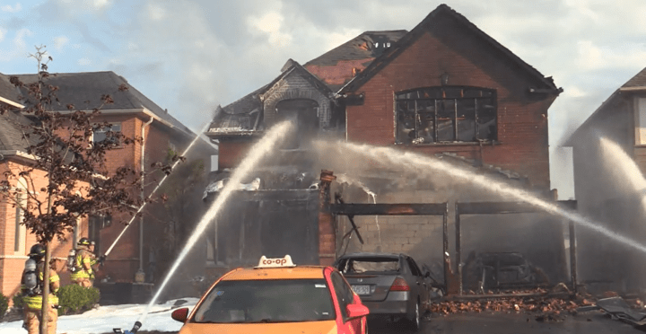 Fire crews battle a house fire in Pickering on Tuesday.