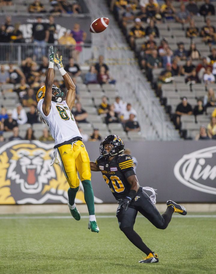 Derel Walker catches a touchdown pass against Hamilton Tiger-Cats’ Mariel Cooper, right, during the first half of CFL football action in Hamilton, Ontario on Thursday August 23, 2018.