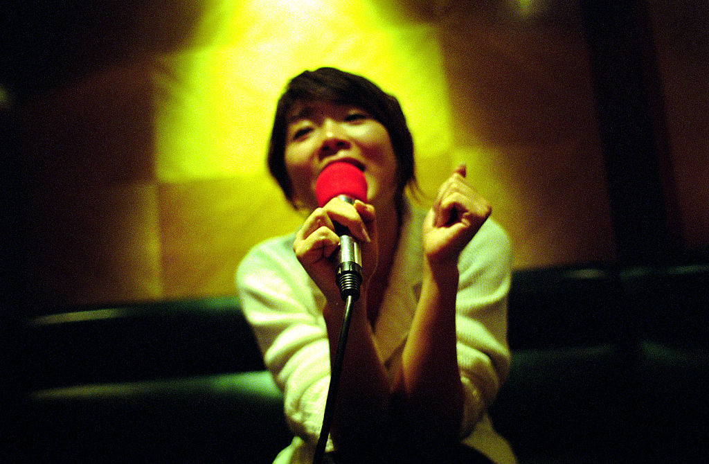 A woman sings her favorite song at a karaoke club in Shanghai, China, in this 2006 file photo.