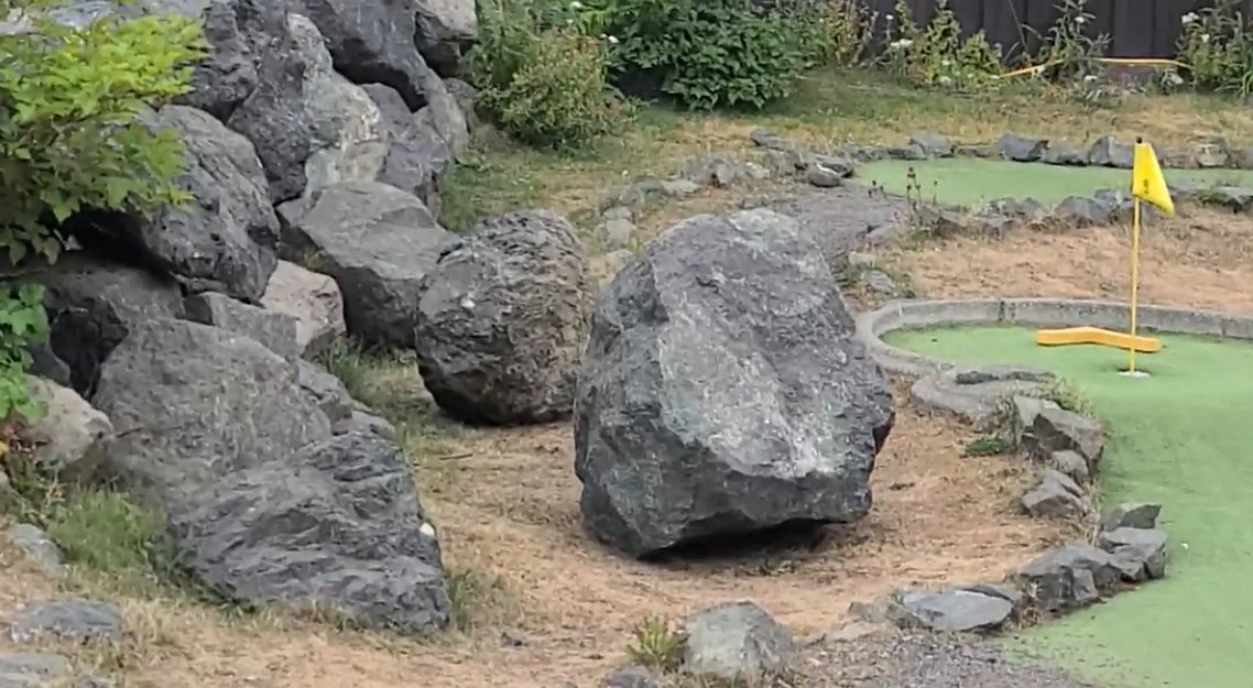 Two large rocks are seen behind police tape at a mini-golf course at Mount Washington Alpine Report where a child died on Friday. 
