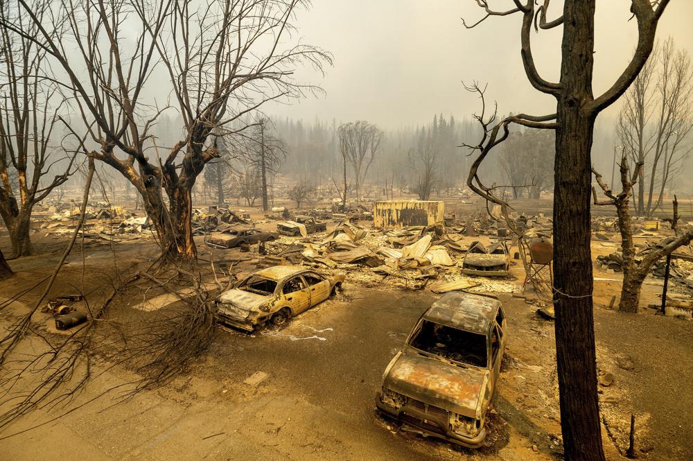 This photo shows cars and homes destroyed by the Dixie Fire line central Greenville on Thursday, Aug. 5, 2021, in Plumas County, Calif.