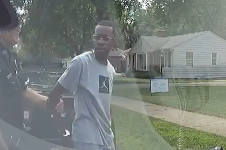 Police handcuff realtor Eric D. Brown outside a home he was showing to clients in Wyoming, Mich., on Aug. 1, 2021.