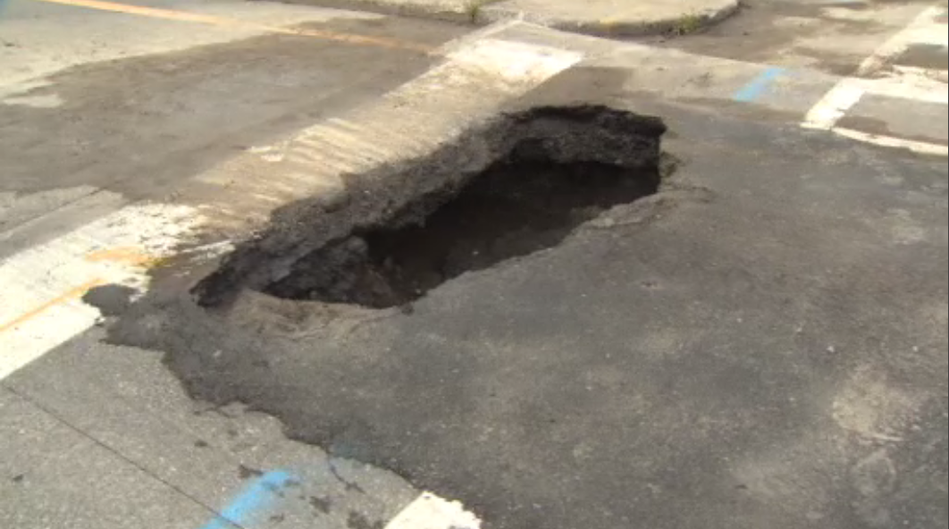 A small sinkhole opened up at the intersection of Bronson Avenue and Brewer Way in Ottawa on Thursday, Aug. 12, 2021.