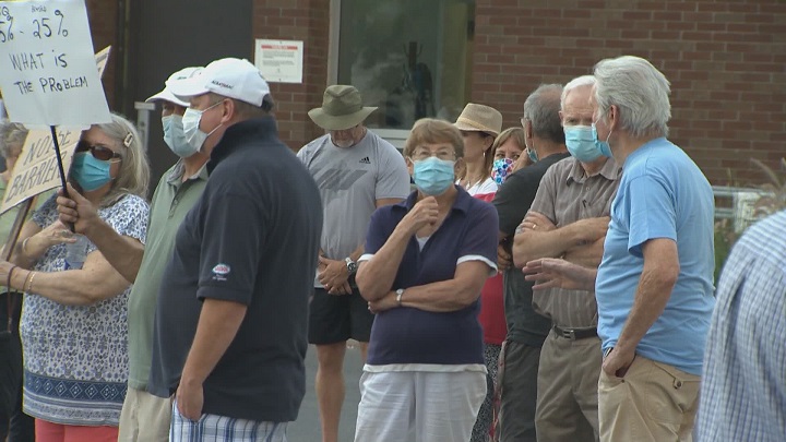 Residents protested outside Beaconsfield City Hall on Monday, Aug. 23, 2021.