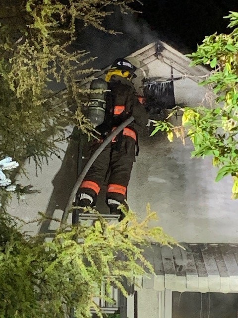A firefighter with the Saskatoon Fire Department is pictured battling a house fire on Sunday morning on Aug. 29 on the 2100 block of St. George Avenue.
