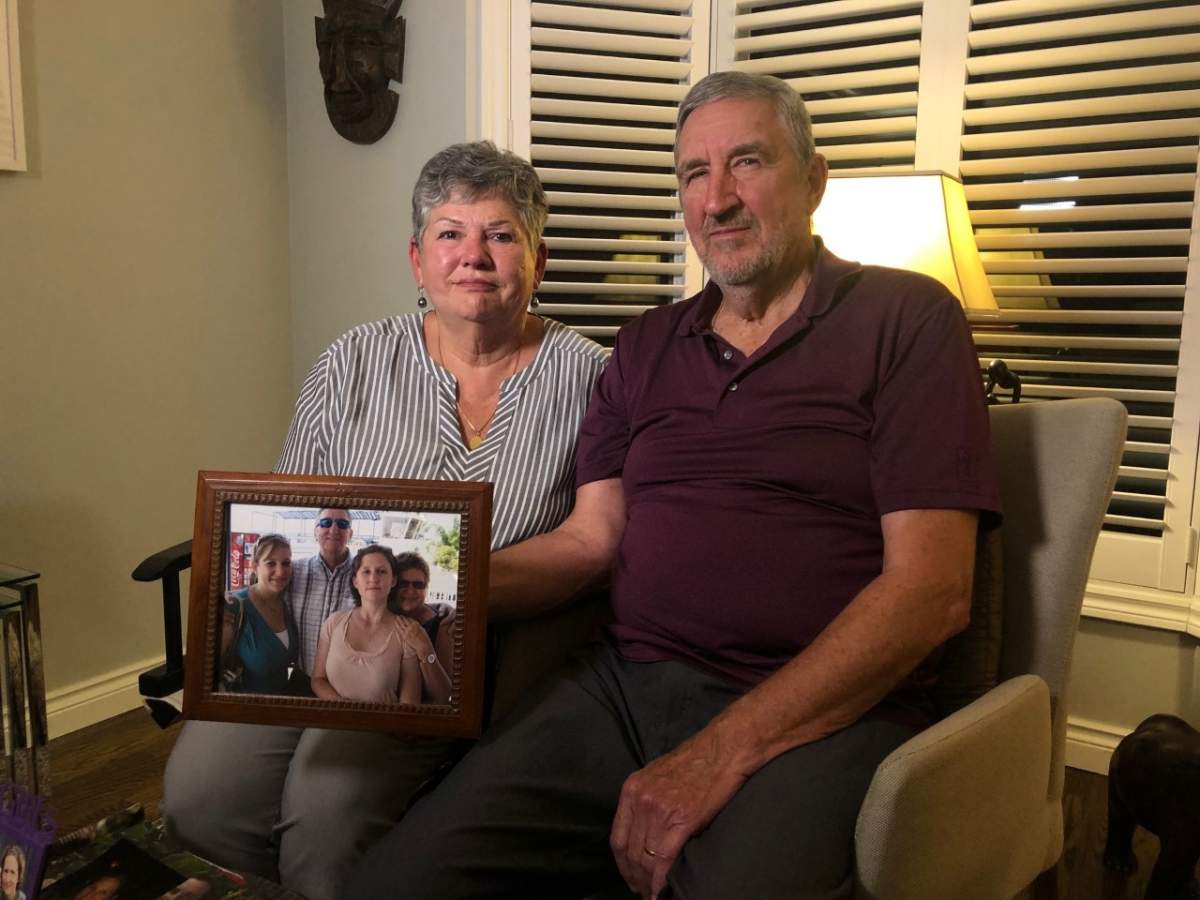 Madeleine and Michel Desloges hold a family portrait, showing their daughter Annemarie, left.