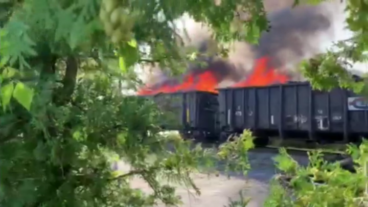 Flames were seen rising from railway cars.