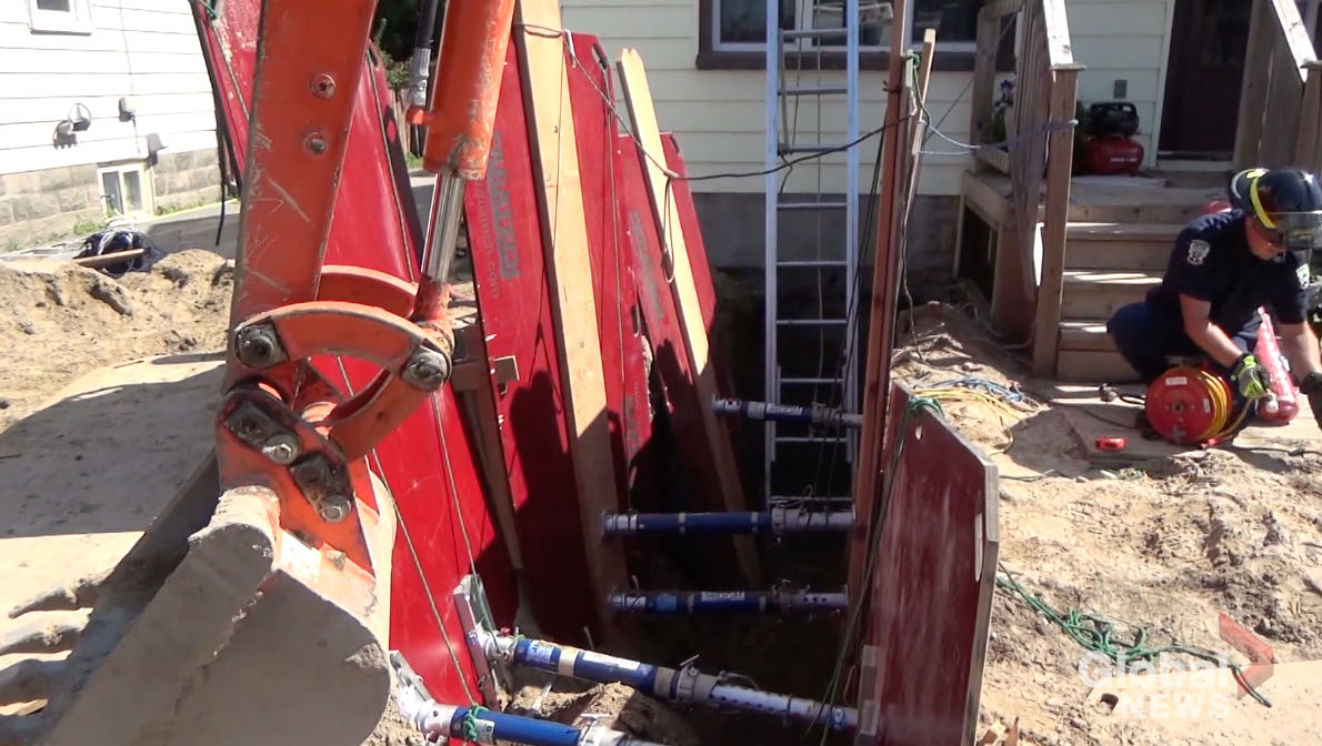 Firefighters assembled shoring trench boxes s to stabilize the trench before attempting to remove the man.