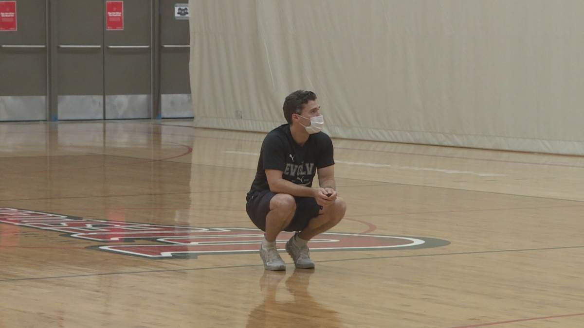 Nick Lother observing a drill at the University of Winnipeg while running an Evolve Basketball camp.